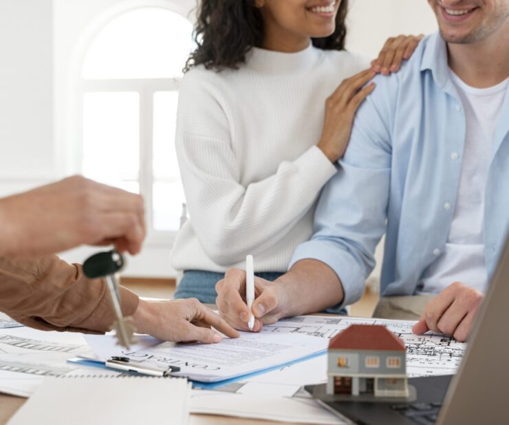 smiley-couple-signing-contract-new-house
